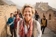 © Anne Schaum - Group portrait photography of a pleased woman in her 40s that is smiling with friends at the Great Wall of China in Beijing China . Generative AI