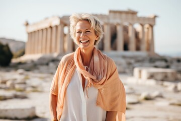 Wall Mural - smiling mature woman in scarf standing near Parthenon on Acropolis