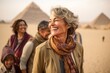 © Anne Schaum - Group of happy senior tourists in the pyramids of Giza, Egypt