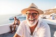© Anne Schaum - Senior man on vacation in Santorini island, Greece. He is smiling and looking at camera.
