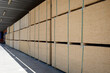 Large outdoor warehouse for wooden plywood sheets of various sizes.
