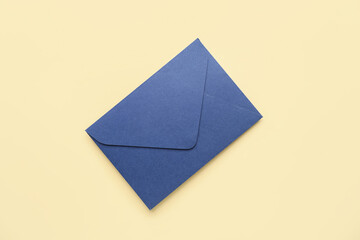 Wall Mural - Blue envelope on yellow background. Message concept