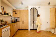 Stylish Studio Apartment Interior In Beige Tones With A Motion Blurred Female Figure Walking