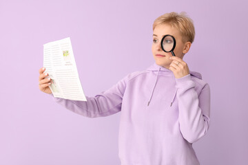 Young woman with magnifier reading newspaper on lilac background