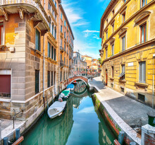 Fabulous Cityscape Of Venice With Narrow Canals, Boats And Gondolas And Bridges With Traditional Buildings