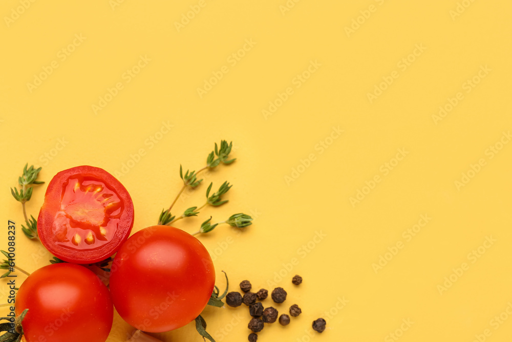 Composition with ripe cherry tomatoes and spices on yellow background, closeup