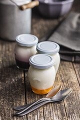 Wall Mural - White and fruit yogurt in jar on wooden table.