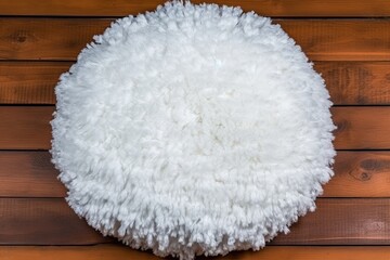 Sticker - white fluffy round pillow against a wooden wall Generative AI