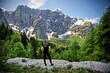 © Vedrana - Mature woman standing at the edge of a cliff in Italian Alps