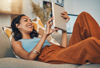 Poster - Woman relax on sofa with tablet, online streaming with internet and reading ebook or watching film at home. Happy female person with technology, subscription and mobile app with break in living room