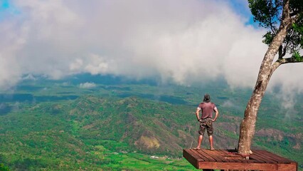 Wall Mural - Silhouette active lifestyle travel people standing on the top scenery view point above the clouds on background majestic volcano Gunung Agung Bali, Indonesia 4K 