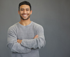 Wall Mural - portrait of man with mockup, arms crossed and smile on studio backdrop in confident casual fashion p