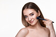 © producer - smiling lovely lady posing with make-up brush for powder