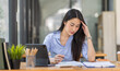© David - Portrait of tired young business Asian woman work with documents tax laptop computer in office. Sad, unhappy, Worried, Depression, or employee life stress concept