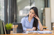 © David - Portrait of tired young business Asian woman work with documents tax laptop computer in office. Sad, unhappy, Worried, Depression, or employee life stress concept