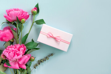 Sticker - Bouquet of beautiful pink peonies with gift boxes in paper wrapping. Banner for congratulations or invitation.