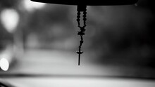 Cross Hanging By Rear View Mirror In Monochrome Black And White