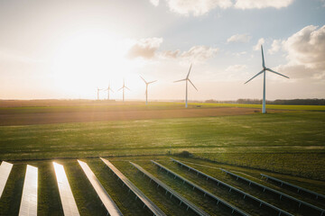 wind turbines and solar panels farm in a field. renewable green energy. sunny landscape, electric en