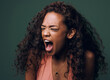 Stress, anxiety and angry woman scream in studio for fear, mistake or psychology crisis on green background. Depression, trauma and anger by female frustrated with mental health problem, fail or ptsd