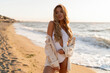 © Svetlana Sokolova - Beautiful blond woman in sexy swimwear posing on the beach in sunset light. Prtfect wavy hairs, tan skim body. Summer tropical mood.
