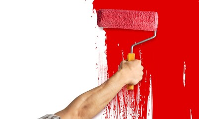 Wall Mural - Painter hand painting the wall interior in red