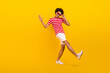 © deagreez - Full size photo of funky guy dance summer vacation active person wear shirt pants shoes sun specs isolated yellow color background