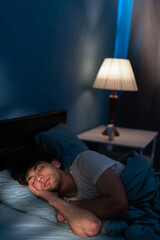 Good sleep concept. Handsome young man sleeping in comfortable bed alone at home, enjoying his orthopedic mattress and pillow