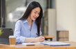 © David - Asian Business woman using calculator and laptop for doing math finance on an office desk, tax, report, accounting, statistics, and analytical research concept
