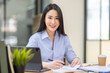 © David - Asian Business woman using calculator and laptop for doing math finance on an office desk, tax, report, accounting, statistics, and analytical research concept