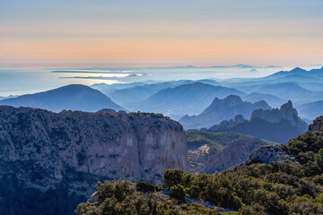 Sunset in the Sierra del Malladar from where you can see the Alicante coast. To the right the Castellets mountain range. In Alicante province, Benimantell, Spain.