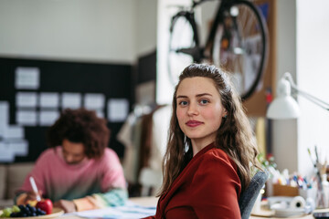 Portrait of young happy woman in office.