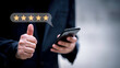© Oatakoi - Customer service experience and business satisfaction survey.close up Man hand using smartphone with popup five star icon for feedback review satisfaction service.