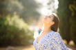 © PheelingsMedia - Woman breathing fresh air in a park alone