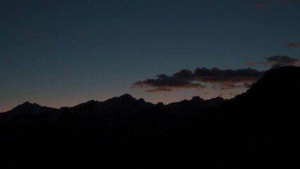 Wall Mural - Moon above the Himalayan mountains after sunset as seen from Langza village in Spiti Valley, Himachal Pradesh, India. Moon above the dark Himalayan mountains after dusk. Natural evening background.