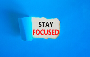 Stay focused symbol. Concept words Stay focused on beautiful white paper on a beautiful blue background. Business, support, motivation, psychological and stay focused concept. Copy space.