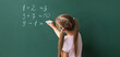 © Pixel-Shot - Cute little schoolgirl writing on blackboard during math lesson