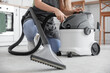 © Pixel-Shot - Young woman with vacuum cleaner in kitchen, closeup