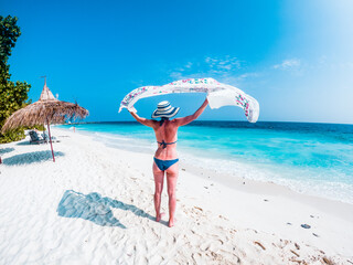 Wall Mural - beautiful woman relaxing on a tropical beach