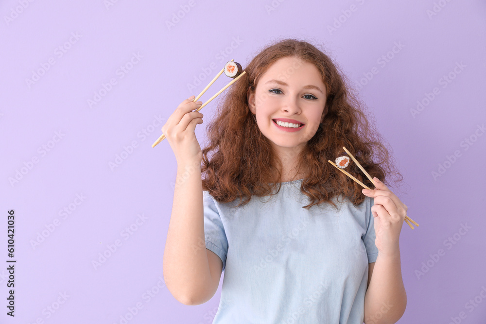 Young woman with sushi rolls on lilac background