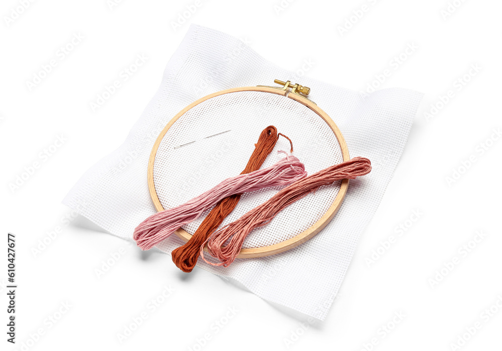 Embroidery hoop with canvas, needle and mouline threads isolated on white background