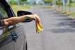 Woman's arm throws fruit waste from car window.  bad behavior of car drivers throwing garbage on the road