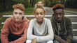 © wetzkaz - young teenagers, underage teenagers, outside in autumn clothes with hat and jacket, friends multicultural multiracial multiethnic, group or friends, classmates, schoolyard or fictional place