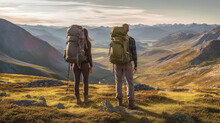 Young Adult Woman And Man With Backpack Hiking In Summer Nature In Rural Area With Flat Mountains And Hills, Meadow On Dirt Trail, Trekking And Camping In Nature