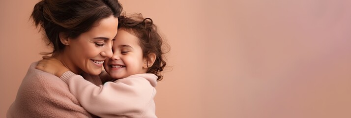 portrait of a mother and child on pink background. mom and baby embrace. mother's day. loving parent