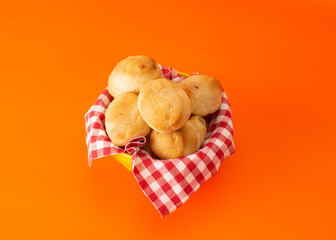 Cheese bread (Brazilian pao de queijo mineiro), top view, isolated, on a basket