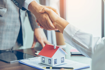 real estate agent shakes hands with customer after finished contract after about home insurance and 