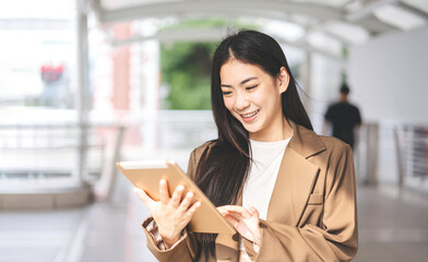 Wall Mural - Business asian woman using digital tablet for internet browsing