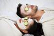© Clement Coetzee/peopleimages.com - Facial, spa and relax with couple and mask for skincare, cosmetics and detox treatment. Beauty, face and self care weekend with man and woman in bedroom at home for salon, wellness and cucumber