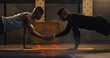 © Armand Burger/peopleimages.com - Fitness, high five and men with floor push up at a gym for support, motivation and training goals. Team, handshake and man with personal trainer for weight training, performance and workout routine