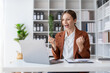 © amnaj - Happy businesswoman raising hands with victory smiling happily with laptop computer. The concept of success at work.